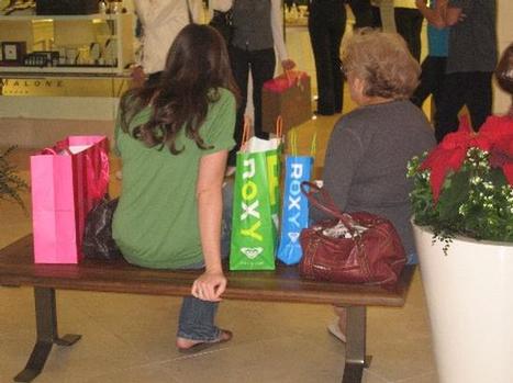 Shoppers take a break at South Coast Plaza during the holiday season last year