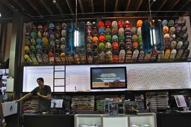 The cash register area includes an artistic display of wheels and houses skate decks.