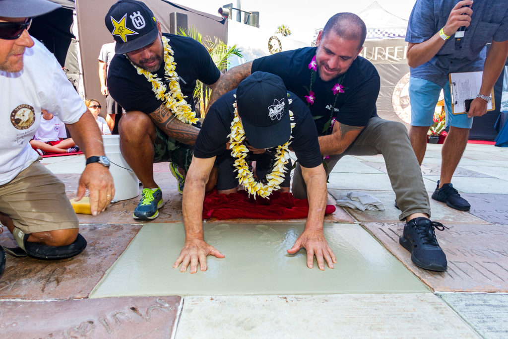 Sunny Garcia and Ben Aipa's son, Duke, help Ben make his mark in cement at the Hall of Fame - Photo courtesy of HSS