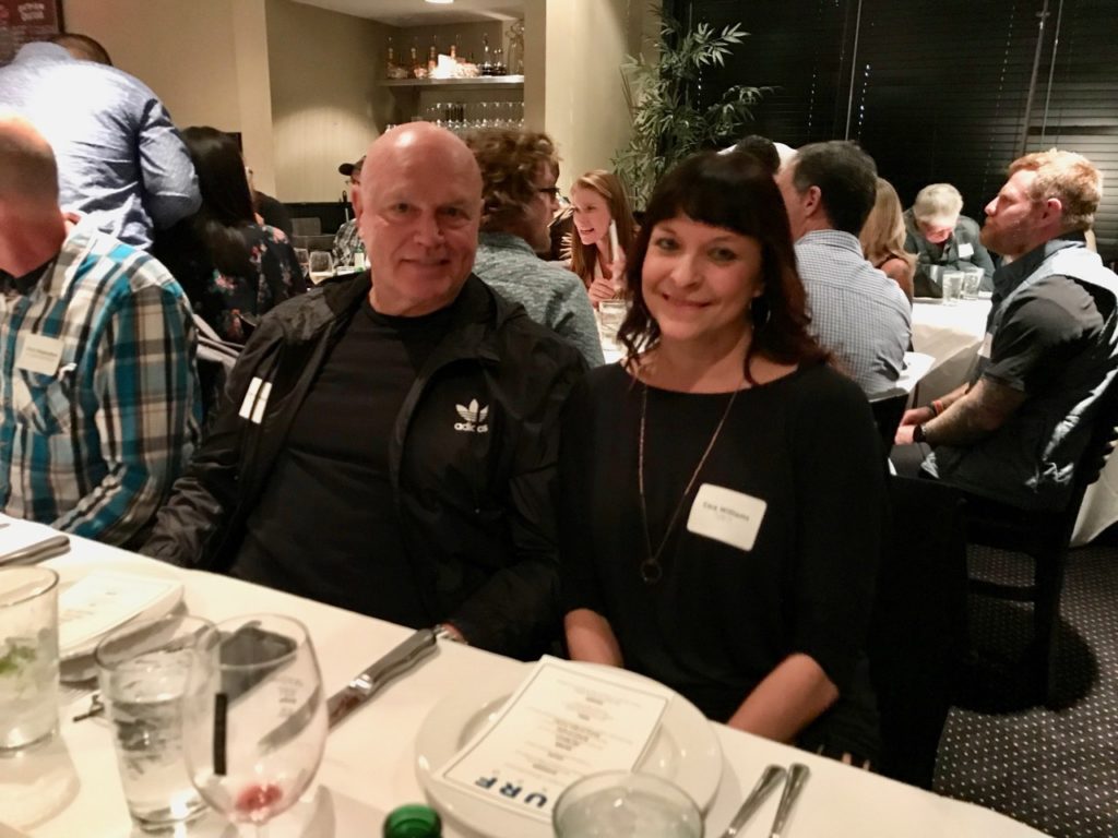 Tyler's Owner Dale Grimes with Senior Buyer Cara Williams at the VIP Dinner at Surf Expo in 2019 - SES file photo