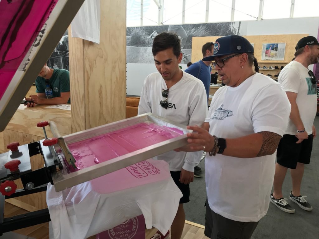 Working with a customer to screen print a T-shirt 