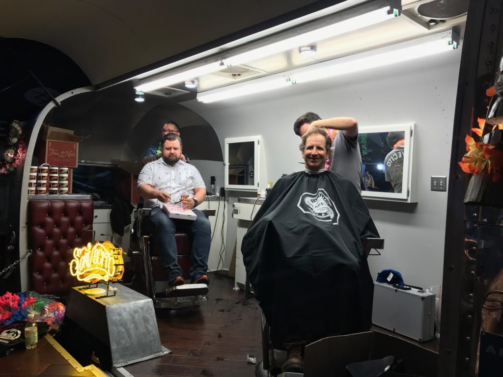 Sauvecito offered haircuts, and Stance's Sam Lovell, right, took advantage of the opportunity