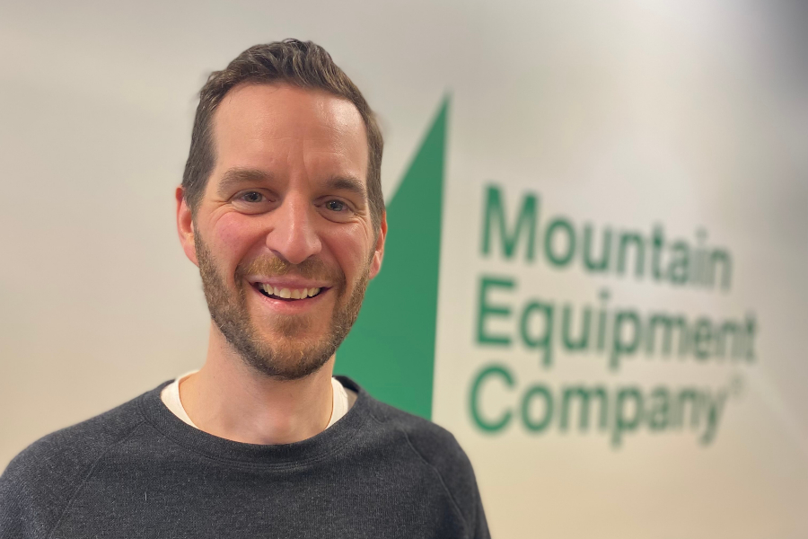 Peter Hlynsky CEO Mountain Equipment Company in front of MEC sign. resized